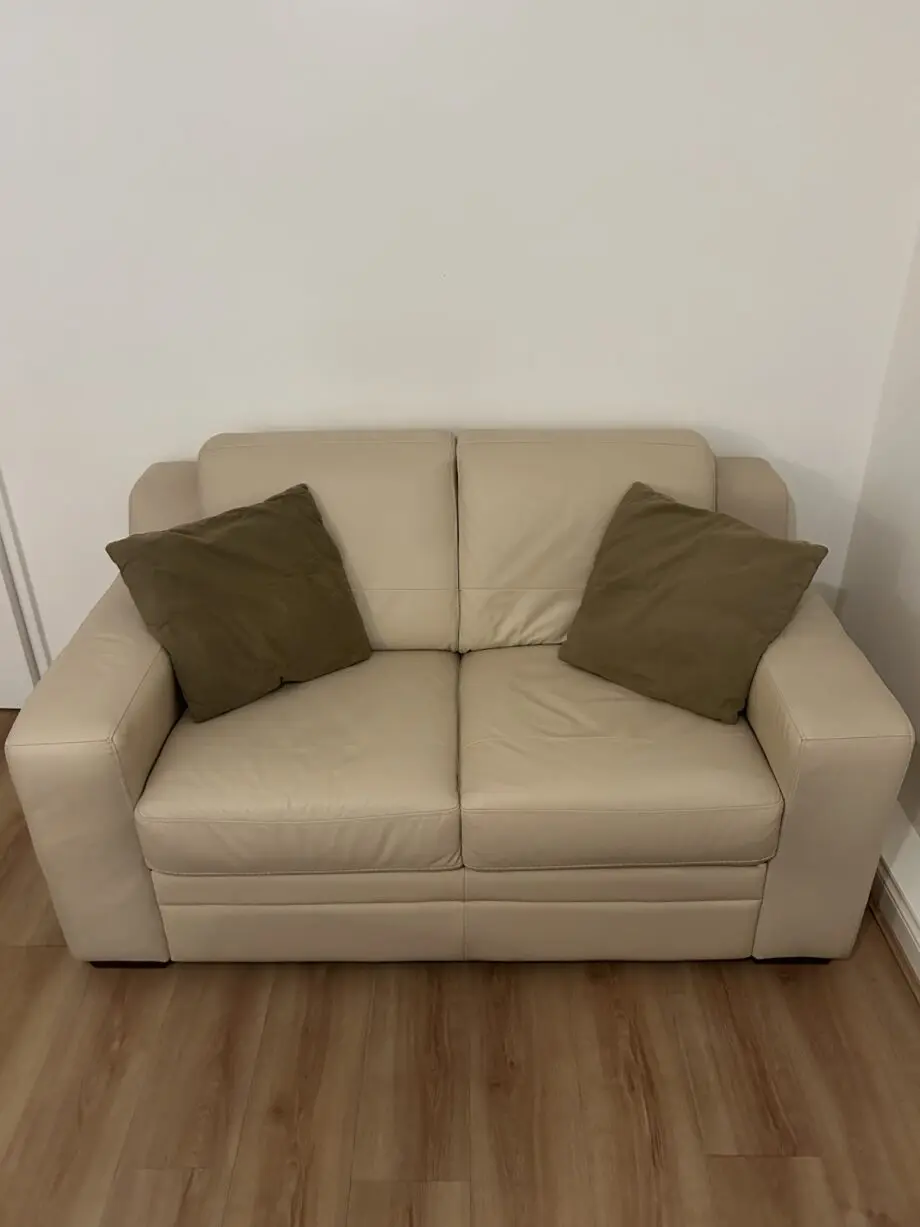 DFS cream two seater leather sofa