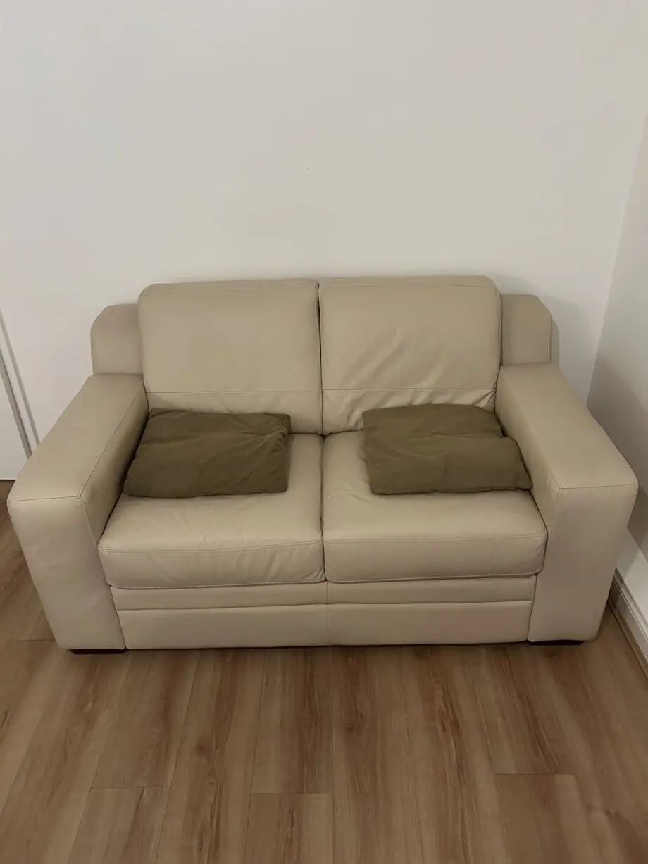 DFS cream two seater leather sofa