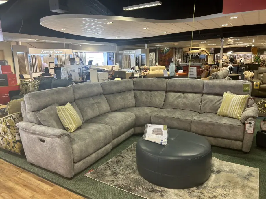 Light silvery grey curved corner sofa, large, from Peter green . Name of sofa is Bentley