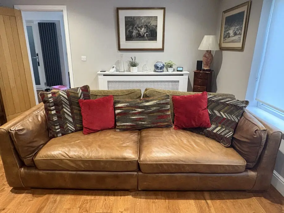 Leather sofas and footstool - furniture village