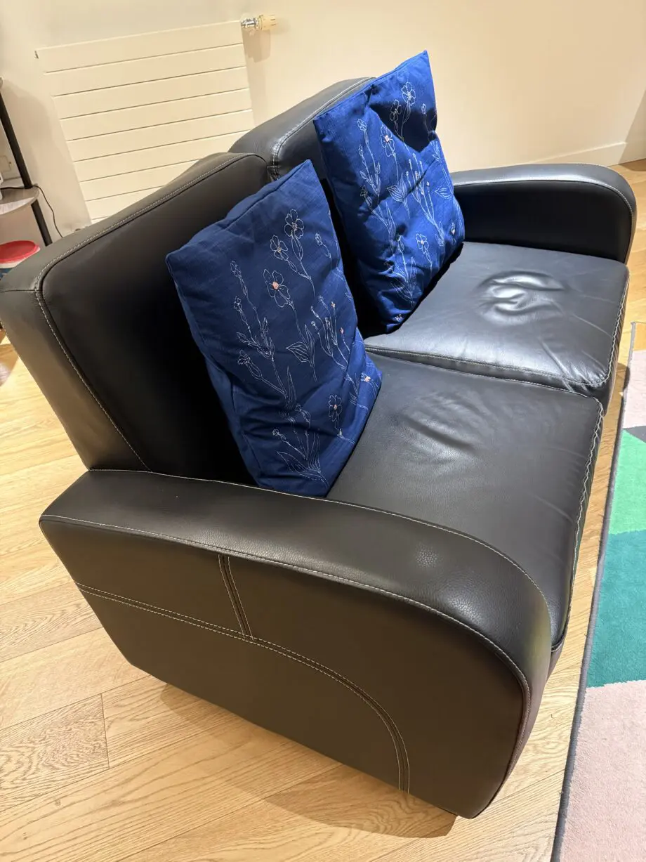 David Phillips black double seater sofa and purple corner sofa