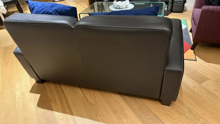 David Phillips black double seater sofa and purple corner sofa