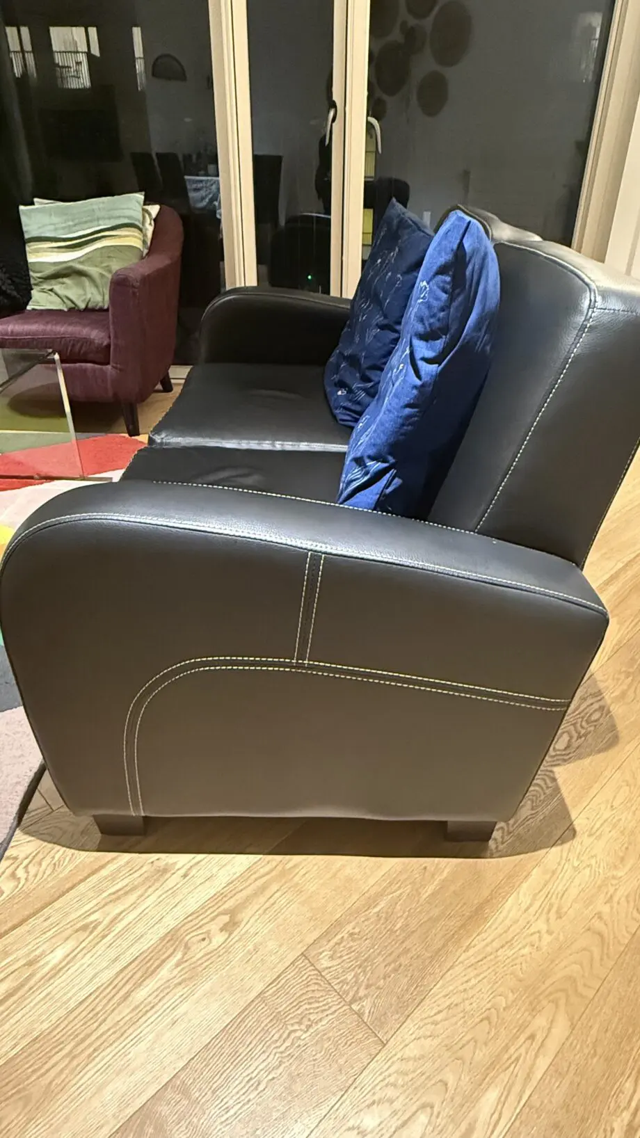 David Phillips black double seater sofa and purple corner sofa