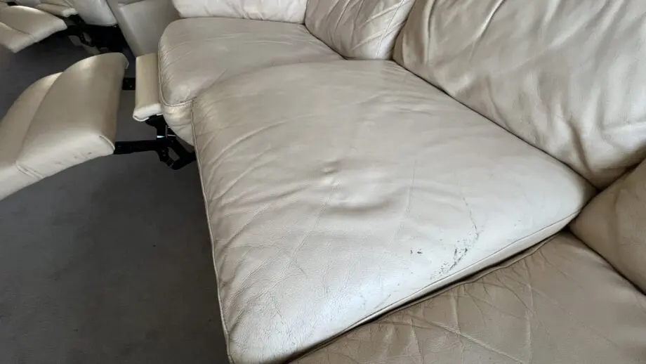 Two ivory leather manual recliner chairs and 3 seat manual recliner sofa with two recliners