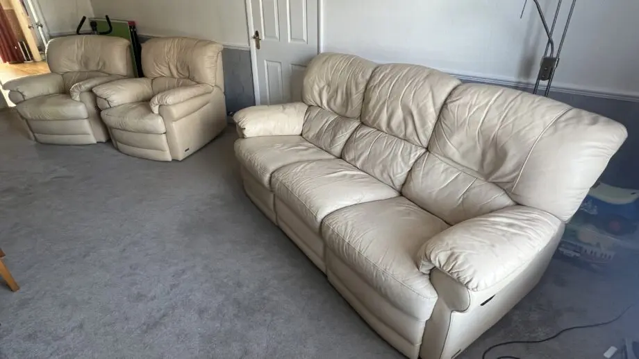 Two ivory leather manual recliner chairs and 3 seat manual recliner sofa with two recliners