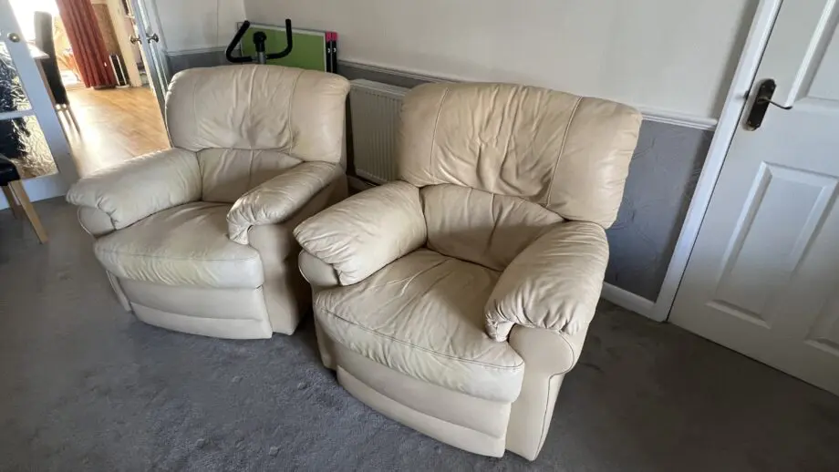 Two ivory leather manual recliner chairs and 3 seat manual recliner sofa with two recliners
