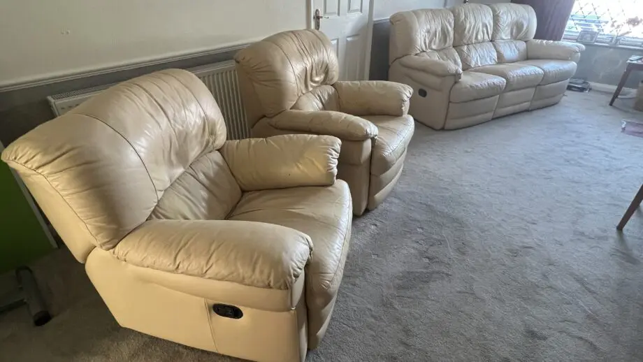 Two ivory leather manual recliner chairs and 3 seat manual recliner sofa with two recliners