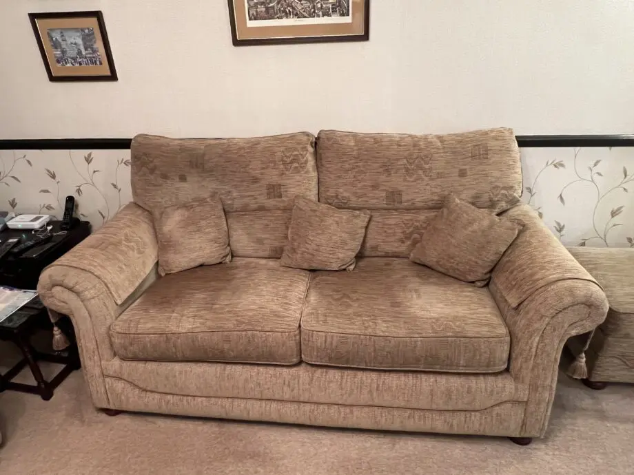Quality made Three seater sofa with 3 matching scatter cushions and opening storage pouffe in beige brown.