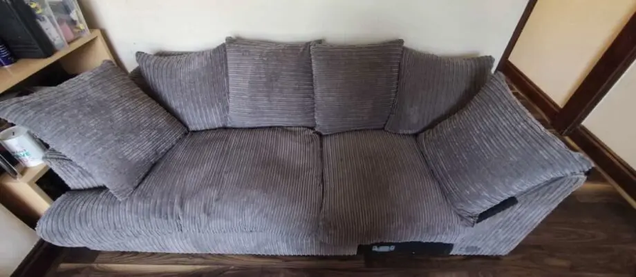 Grey three seater sofa with cushions