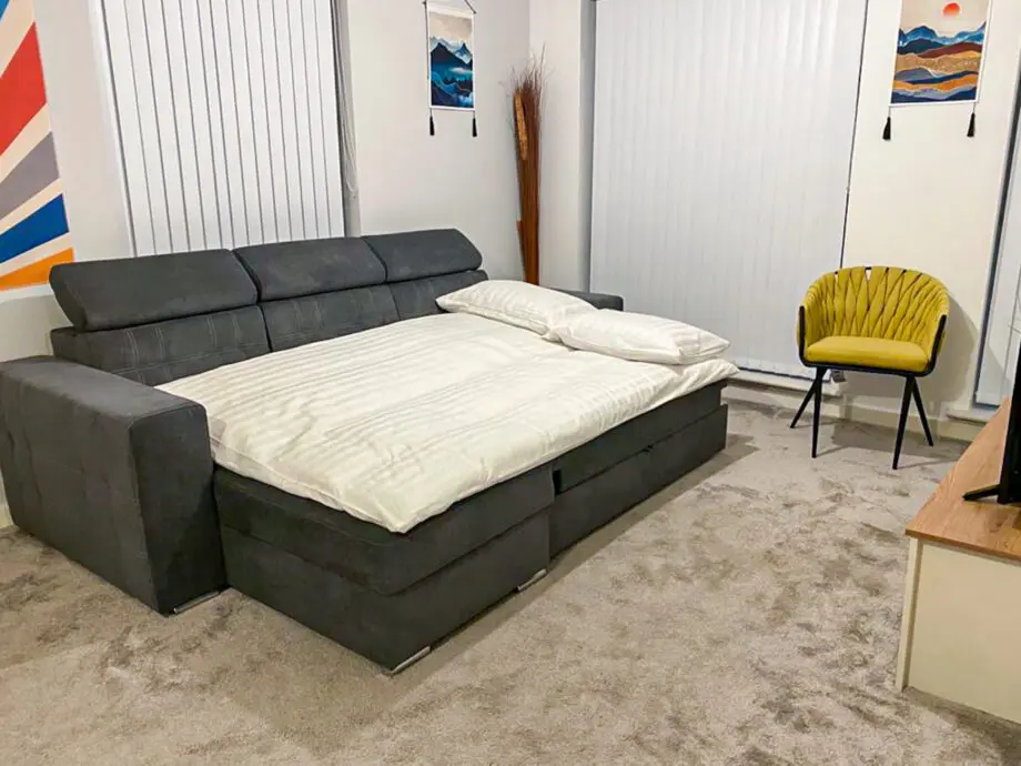 Grey L-shaped sofa bed