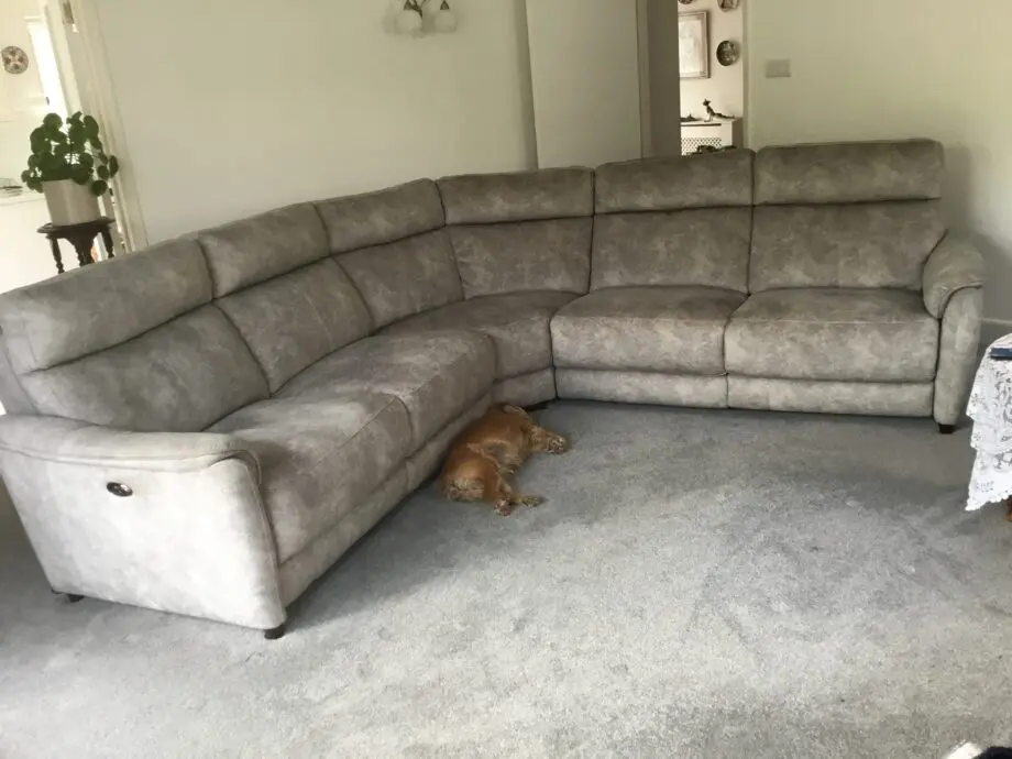 Light silvery grey curved corner sofa, large, from Peter green . Name of sofa is Bentley