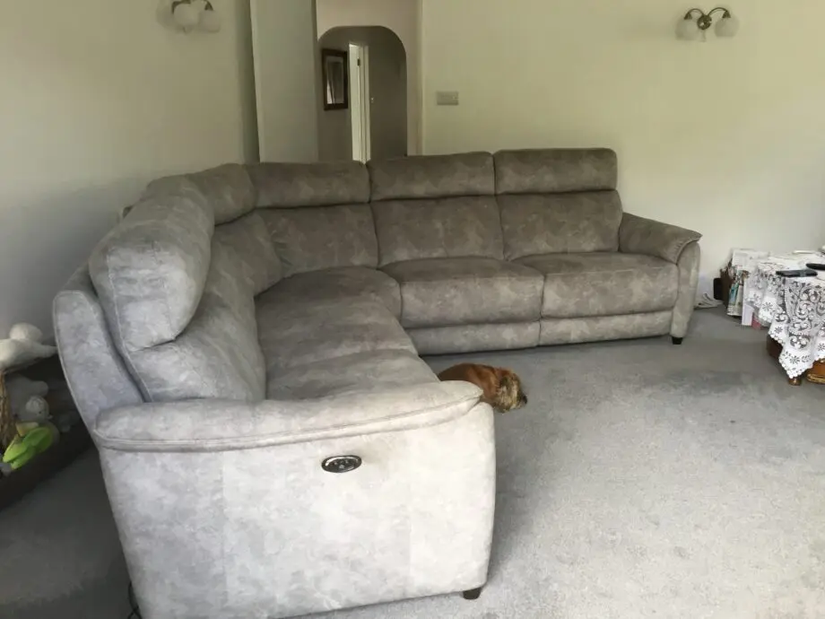 Light silvery grey curved corner sofa, large, from Peter green . Name of sofa is Bentley