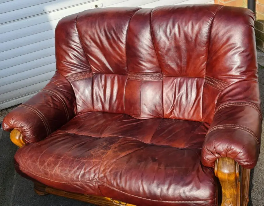 Maroon 2 seater leather sofa.