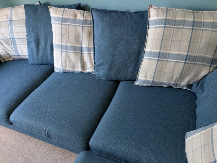 Navy blue corner sofa with scatter cushion back