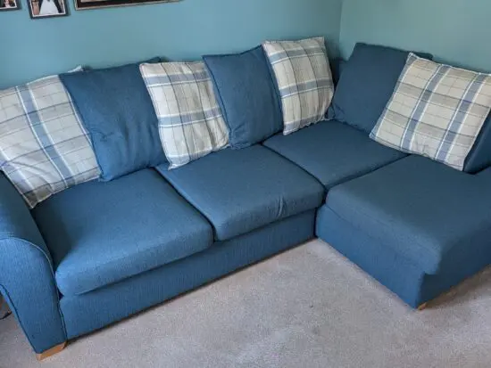 Navy blue corner sofa with scatter cushion back