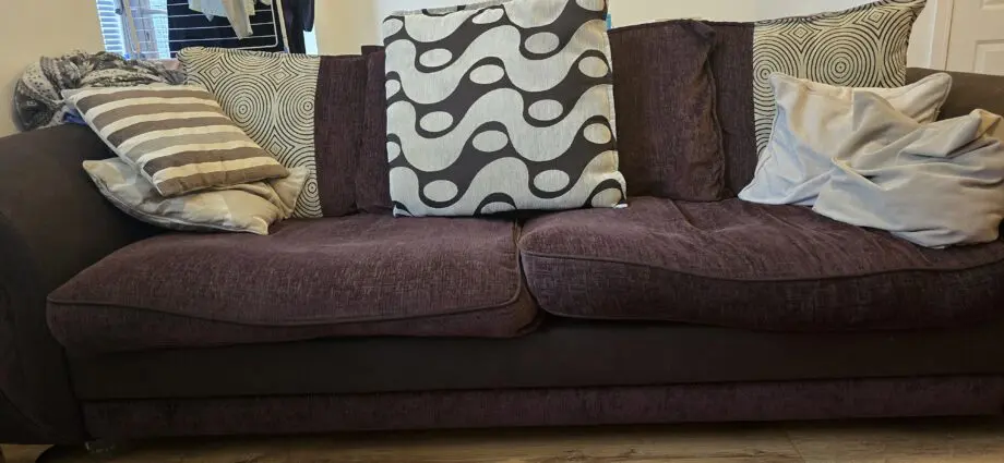 Cushion backed brown three seater sofa and brown armchair
