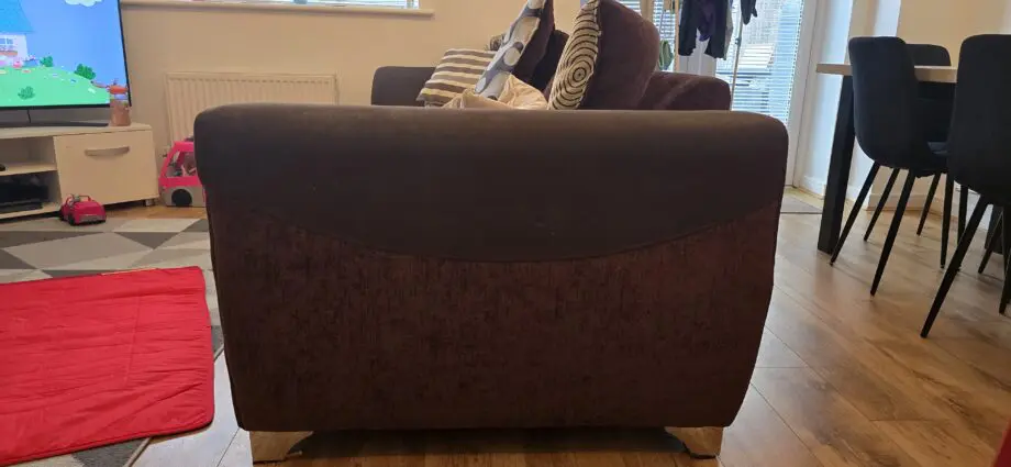 Cushion backed brown three seater sofa and brown armchair