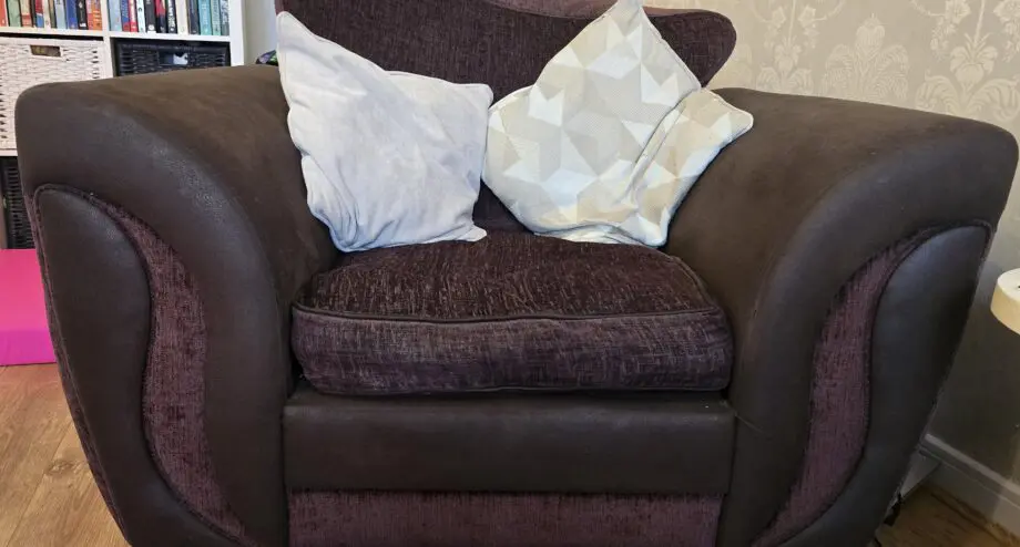 Cushion backed brown three seater sofa and brown armchair