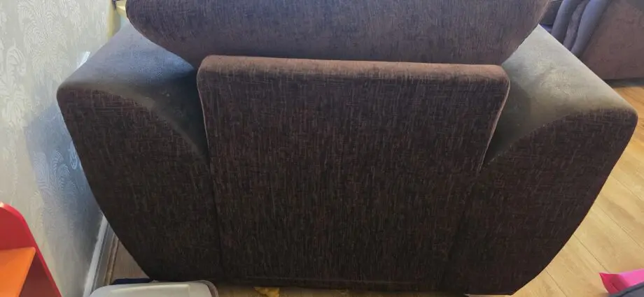 Cushion backed brown three seater sofa and brown armchair