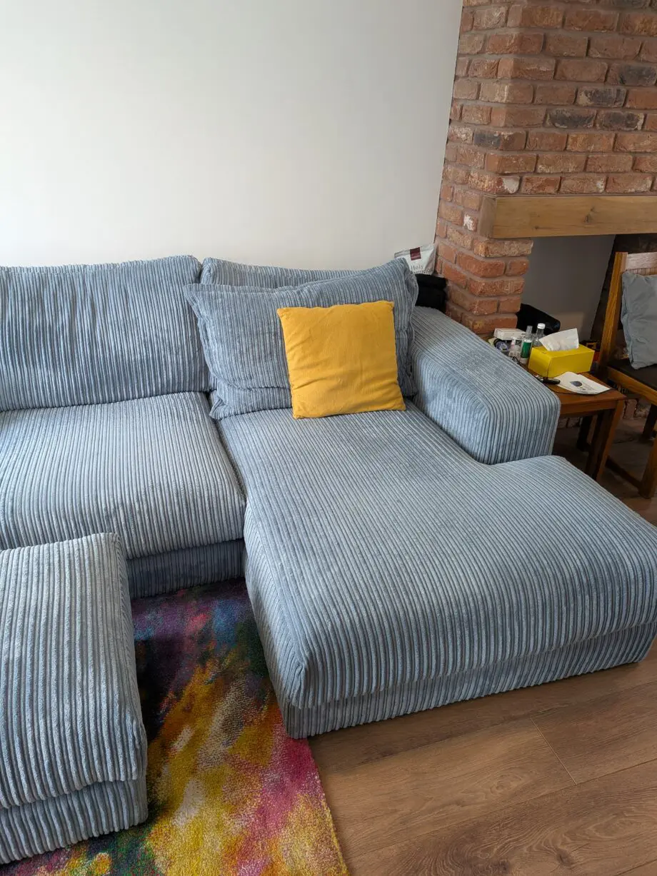 DfS right hand facing 3 seater csofa.haise sofa with large bench footstool ,in rest cord material,sky blue in color.