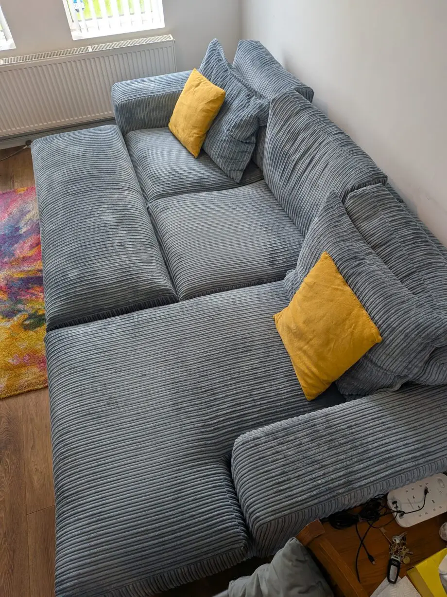 DfS right hand facing 3 seater csofa.haise sofa with large bench footstool ,in rest cord material,sky blue in color.
