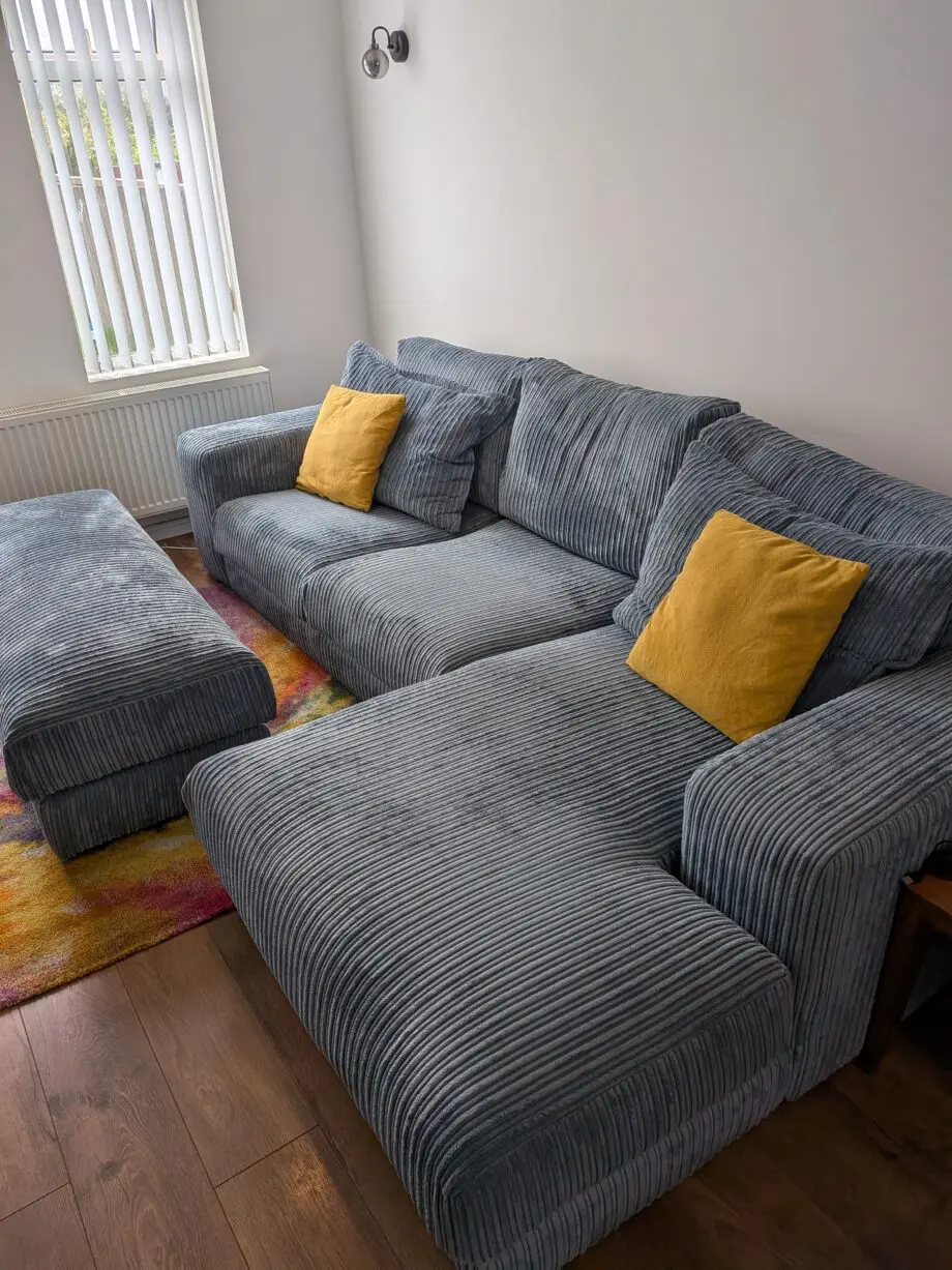 DfS right hand facing 3 seater csofa.haise sofa with large bench footstool ,in rest cord material,sky blue in color.