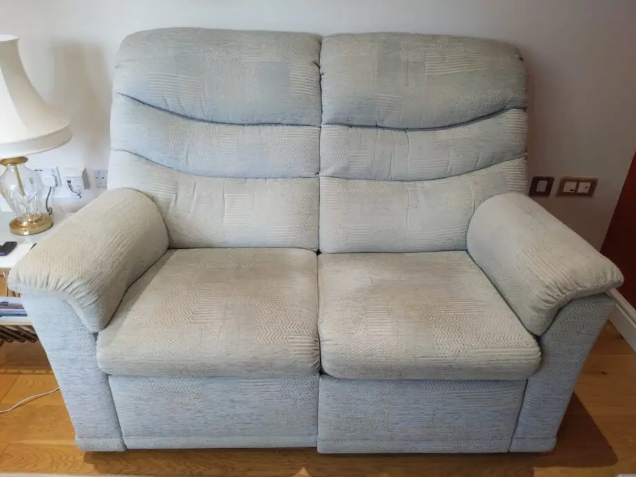 Furniture Village G Plan, high-backed 2 seater recliner sofa in grey with matching footstool