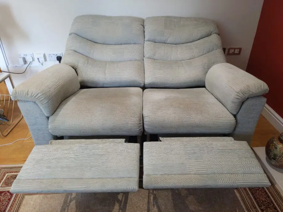 Furniture Village G Plan, high-backed 2 seater recliner sofa in grey with matching footstool