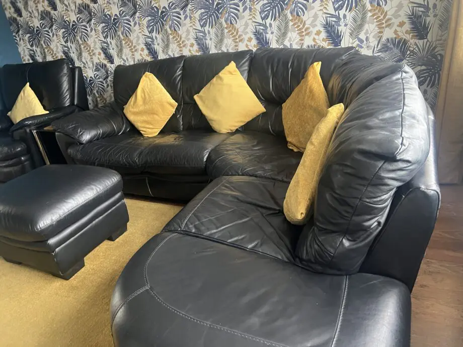 DFS black leather corner sofa & chair