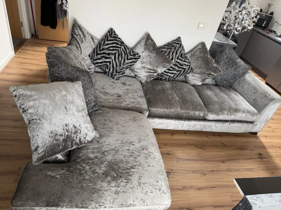 Crushed velvet grey corner sofa from DFS with matching footstool with storage
