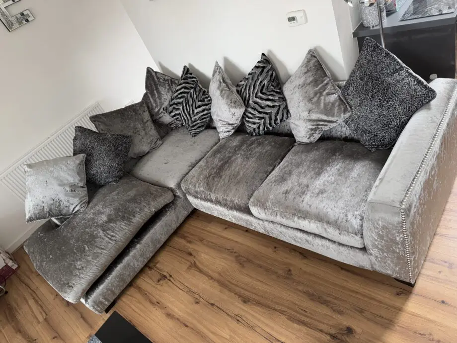 Crushed velvet grey corner sofa from DFS with matching footstool with storage