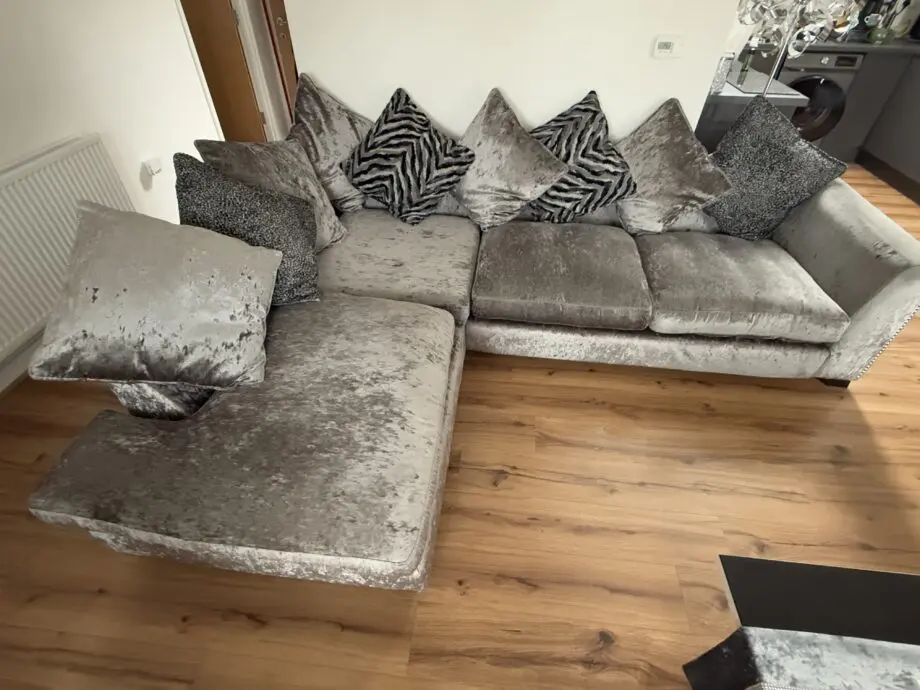 Crushed velvet grey corner sofa from DFS with matching footstool with storage