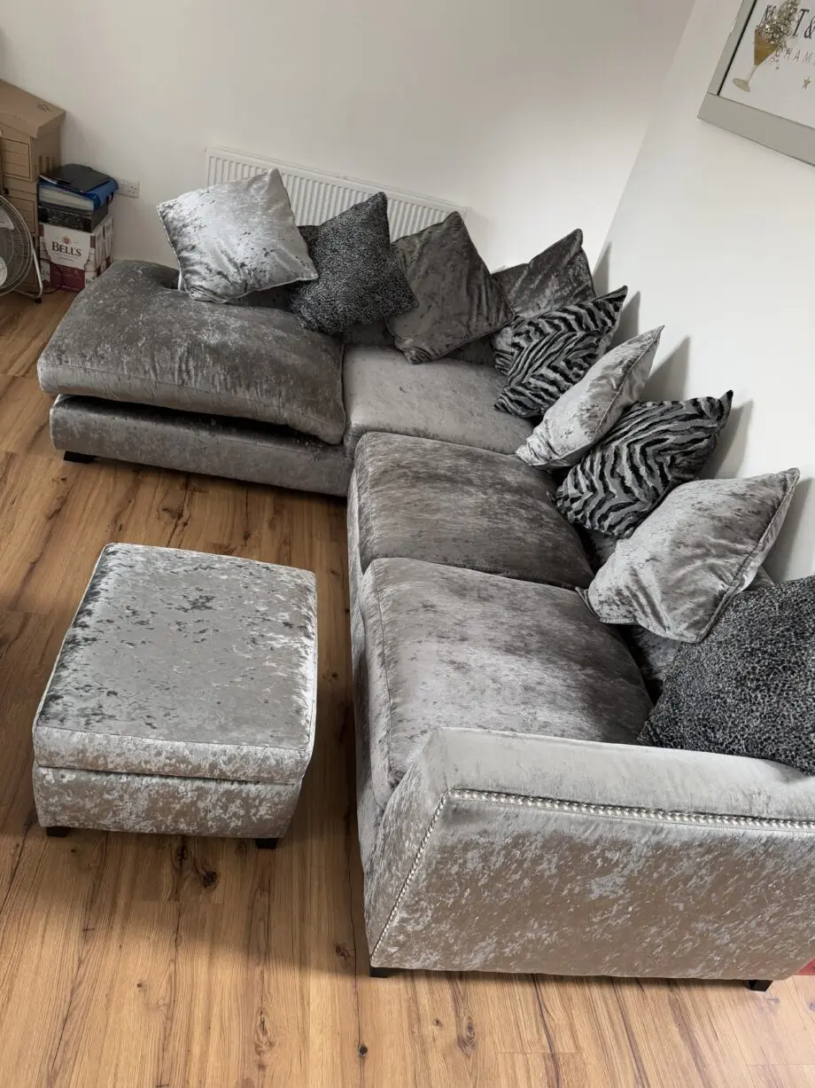 Crushed velvet grey corner sofa from DFS with matching footstool with storage