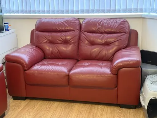 Two seater burgundy/maroon sofa 10 years old