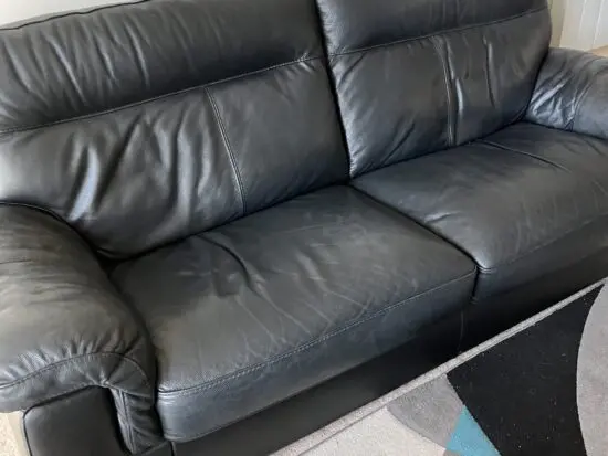 Sofology 3 seater black leather sofa and leather footstool