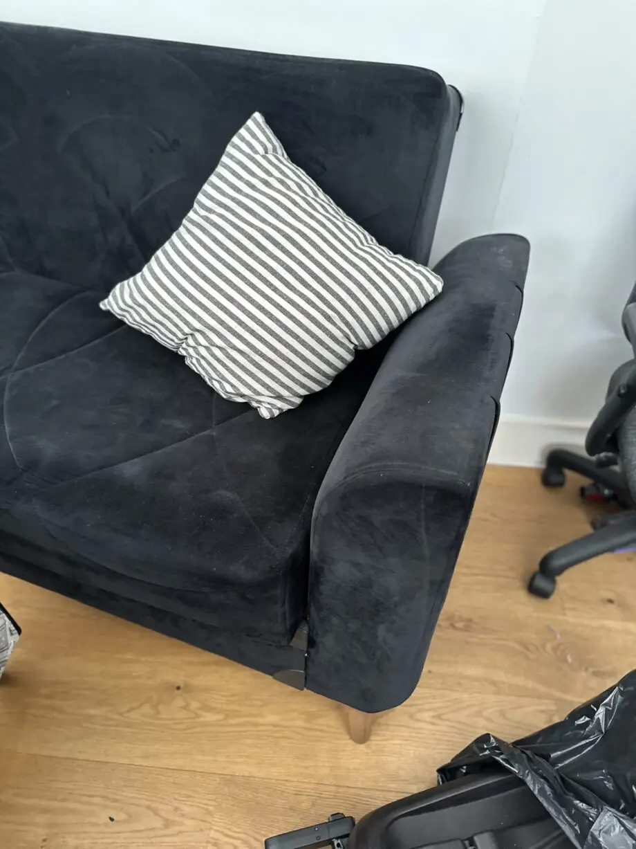 Comfortable and well-maintained 3-seater black sofa bed.