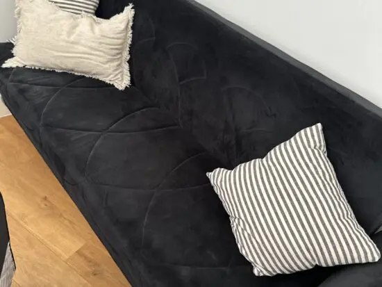 Comfortable and well-maintained 3-seater black sofa bed.