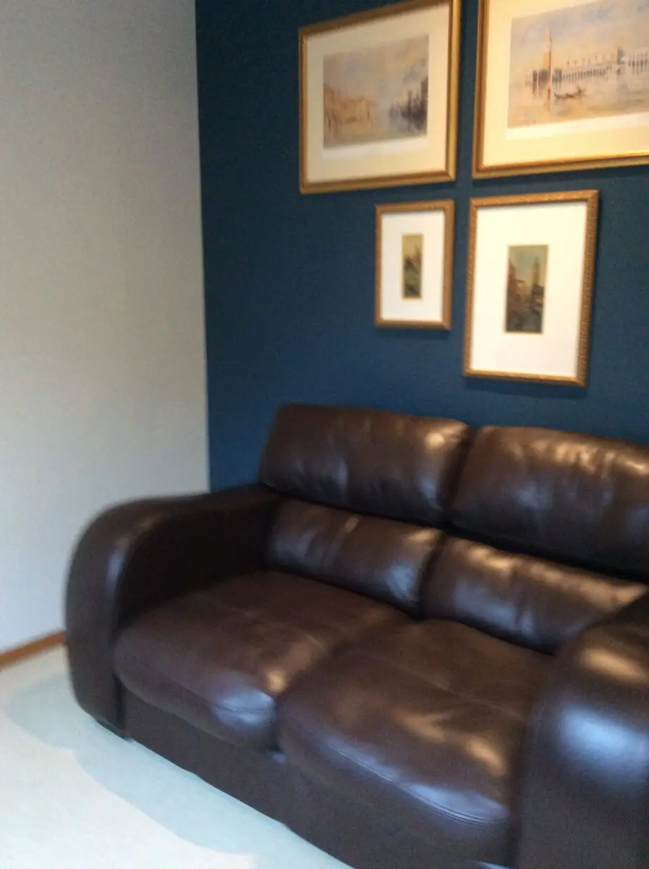 Brown leather 2 seater and matching footstool