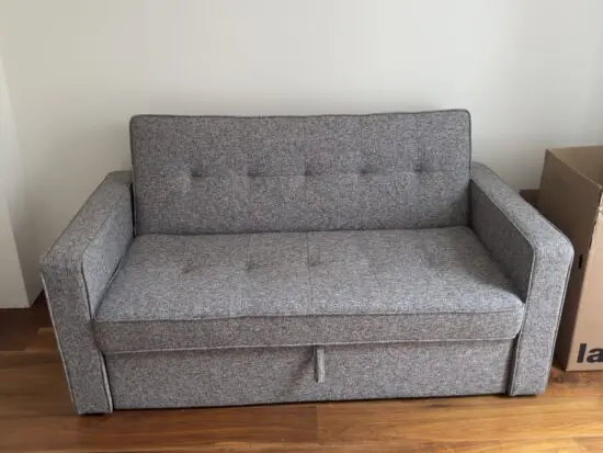 Grey 2-seater sofa bed used in excellent condition