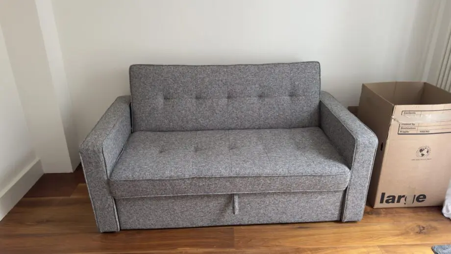 Grey 2-seater sofa bed used in excellent condition