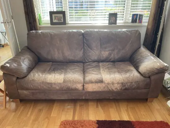 DFS - Distressed brown leather matching sofas.