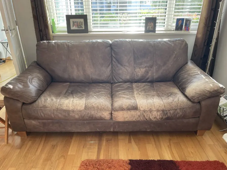 DFS - Distressed brown leather matching sofas.