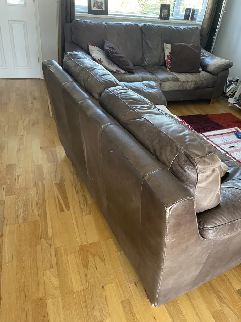 DFS - Distressed brown leather matching sofas.
