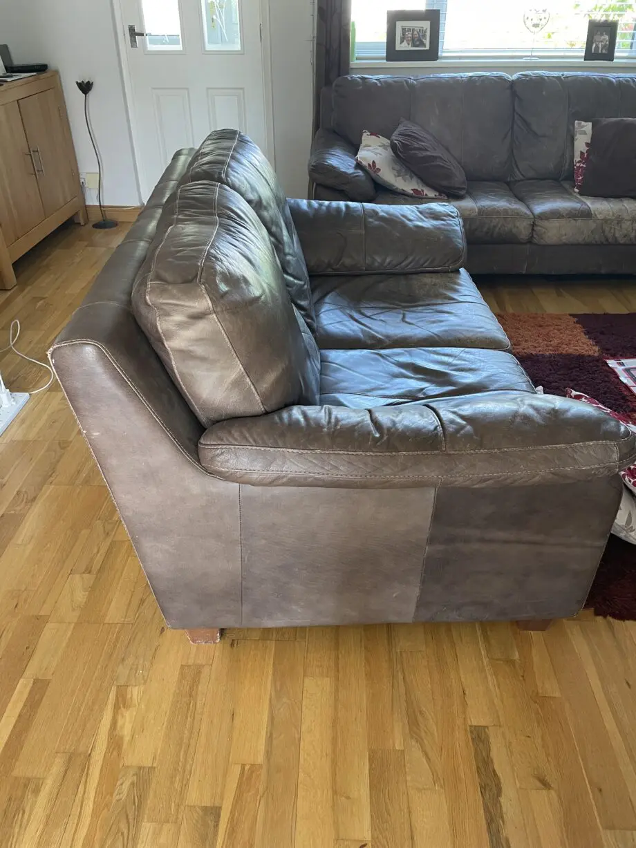 DFS - Distressed brown leather matching sofas.