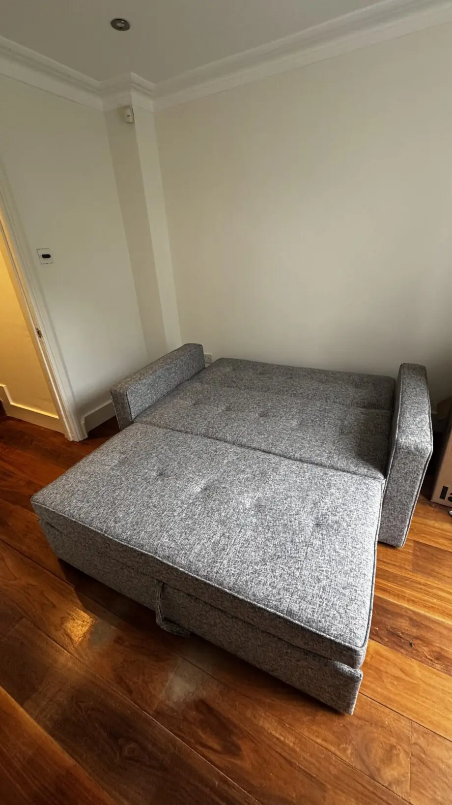 Grey 2-seater sofa bed used in excellent condition