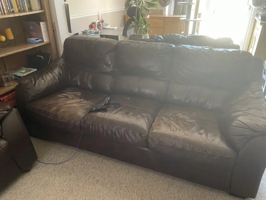 2 x dark brown leather sofa, well used but have some life. Would be ideal for a out building. One sofa has a very small ri0