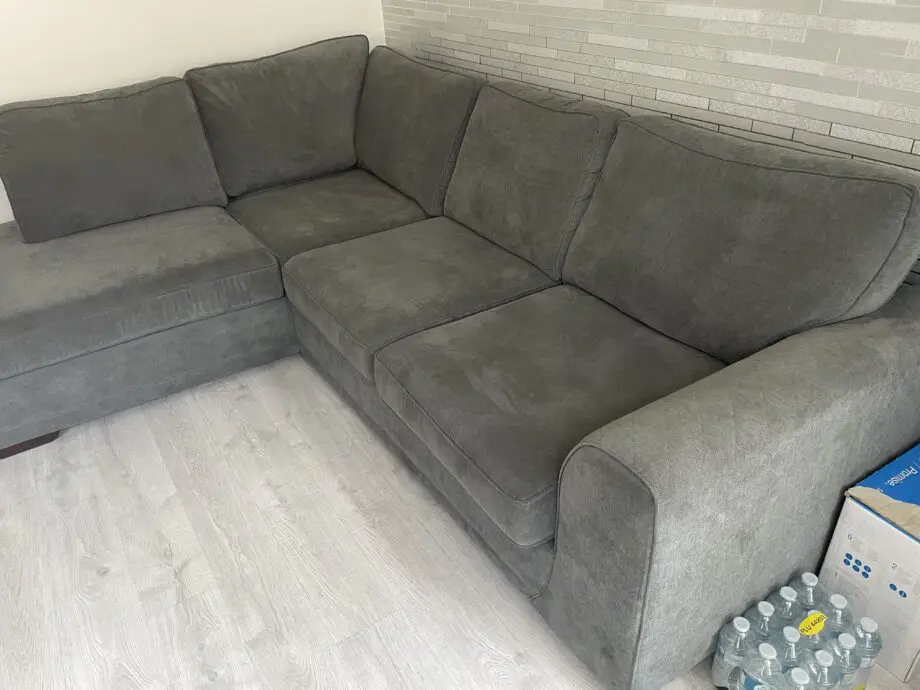 DFS grey ORKA corner sofa with matching foot stool