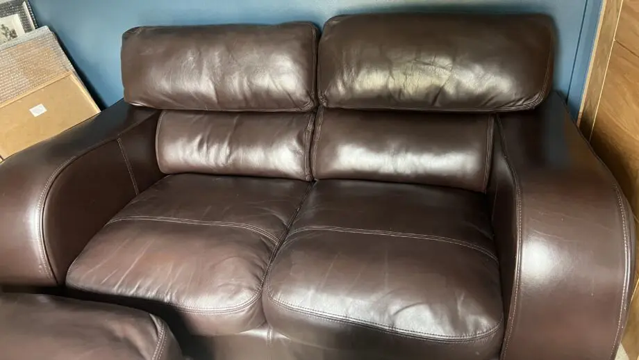 Brown leather 2 seater and matching footstool