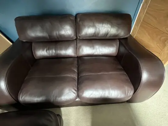 Brown leather 2 seater and matching footstool