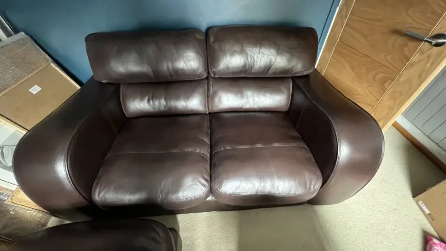 Brown leather 2 seater and matching footstool